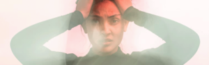 Female struggling with pain in her head